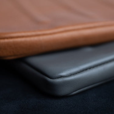 Two leather laptop sleeves