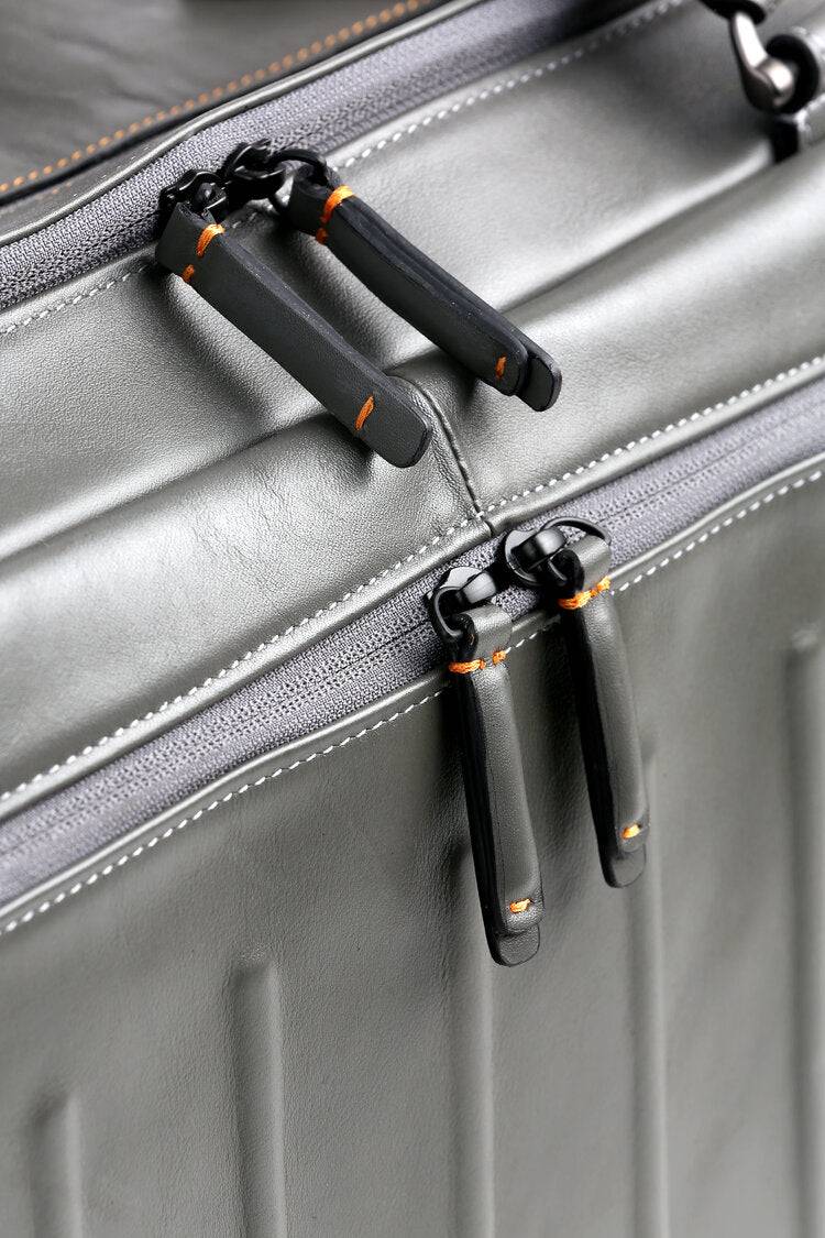 Gray leather duffel bag zipper view