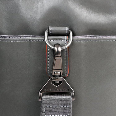 Gray leather duffel bag handle view