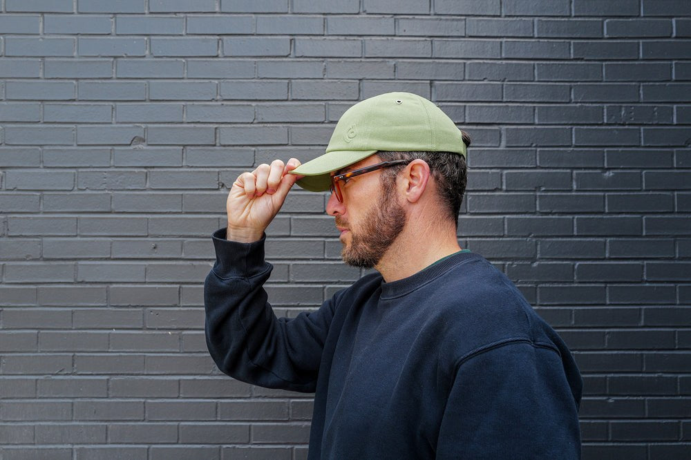 A person wearing the Discommon embossed cap
