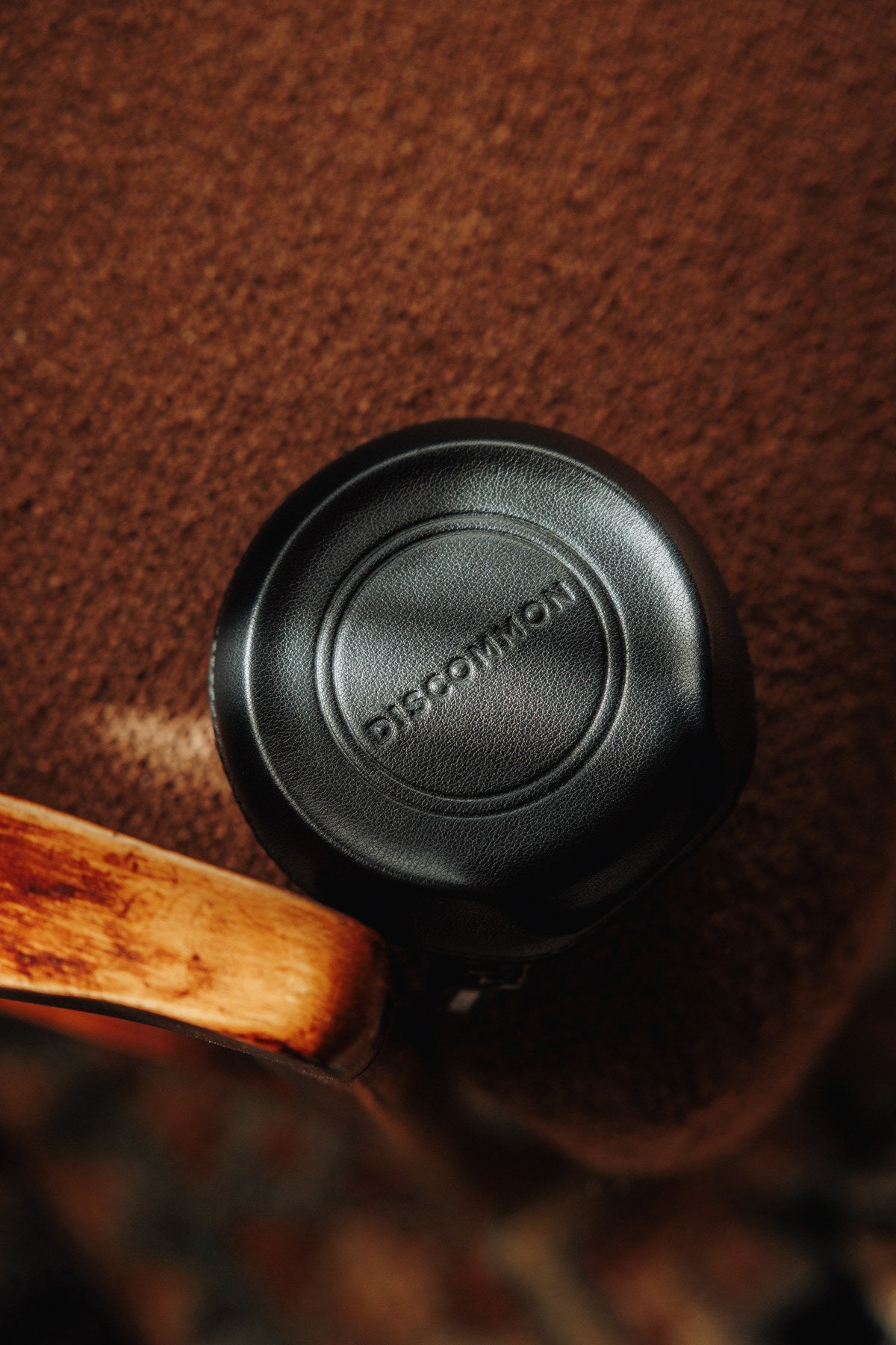 The Puck resting on a brown leather chair