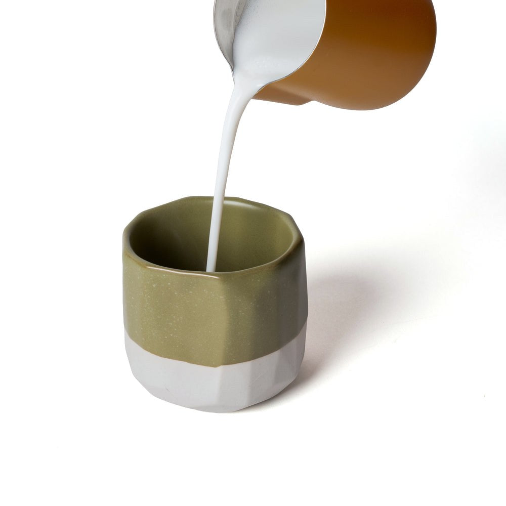 Milk being poured into the olive Nostalgia Killer cup